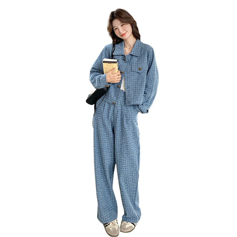 Person wearing a blue outfit holding a coffee cup on a white background
