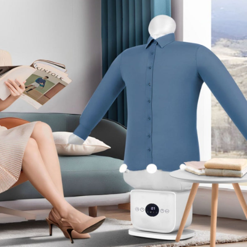 Woman reading a book on a couch with a mannequin wearing a blue shirt and a white appliance in a room.