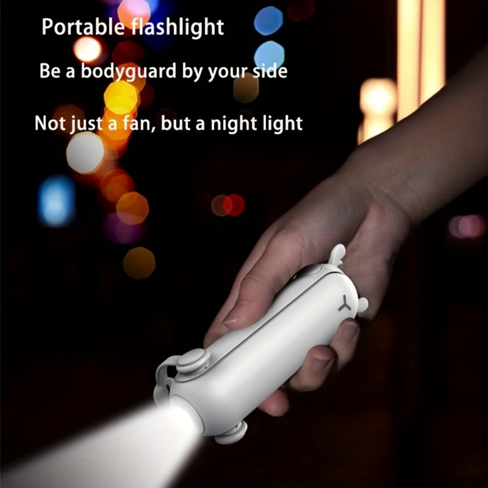 Hand holding a portable flashlight with colorful lights in the background